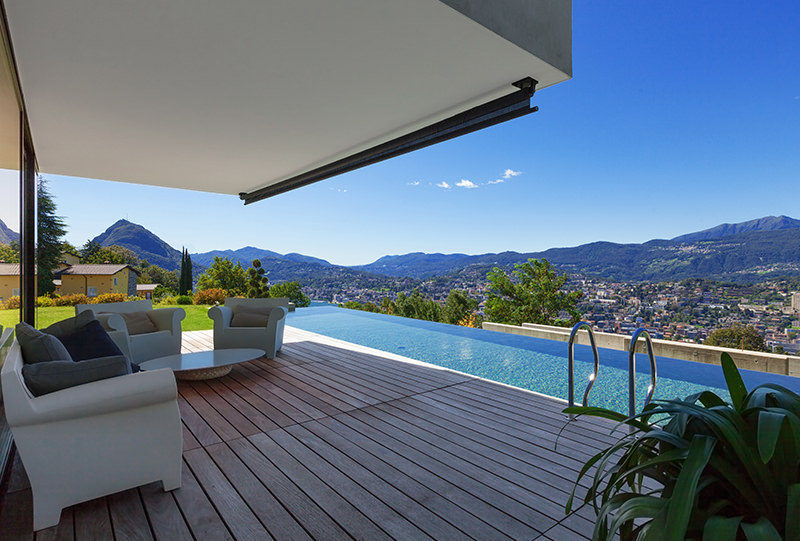 A pool with a view of the mountains and city.